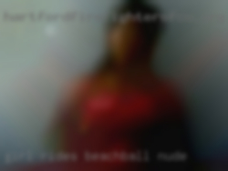 Girl rides beachball nude.